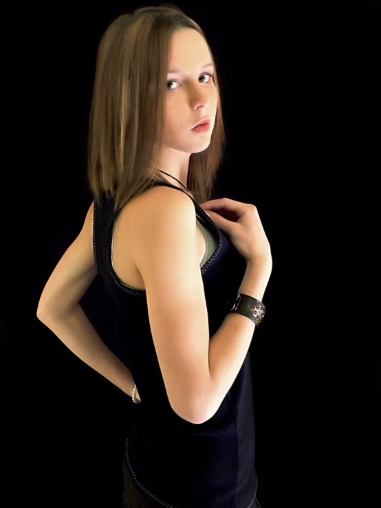 a woman with long hair wearing a black dress