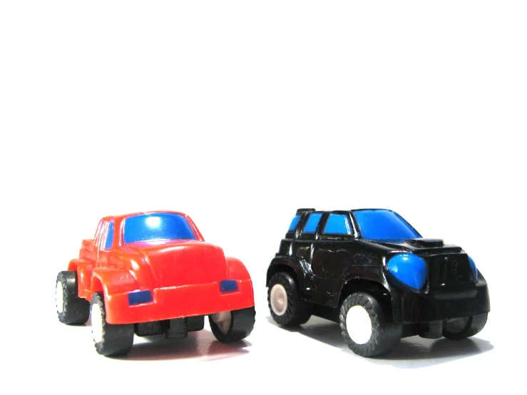 a couple of plastic toy vehicles next to each other