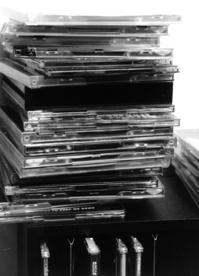 piles of cds are sitting next to each other