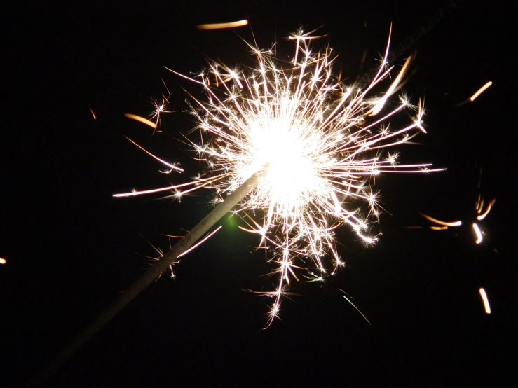 a fireworks on top of a pole at night