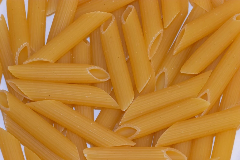 a large bowl filled with macaroni noodles on top of a table