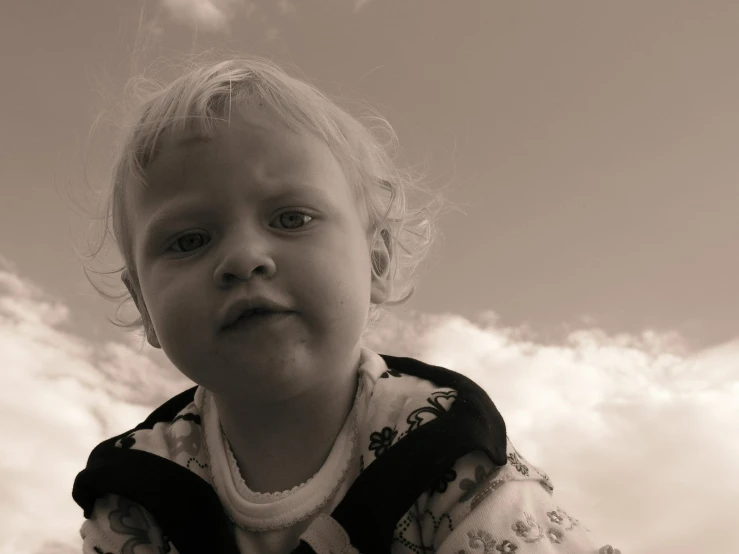 a  is standing in front of the clouds