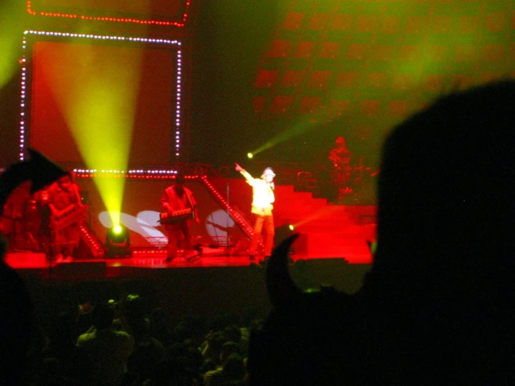 two men with their arms in the air on stage