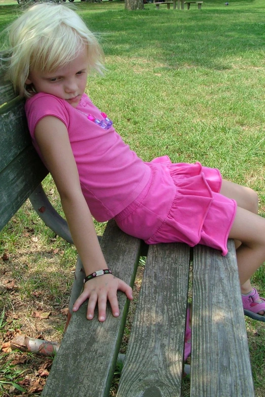 a young child sitting on top of a bench