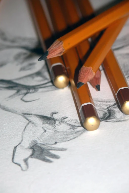 pencils are sticking out of a drawing, with a pencil stuck into one