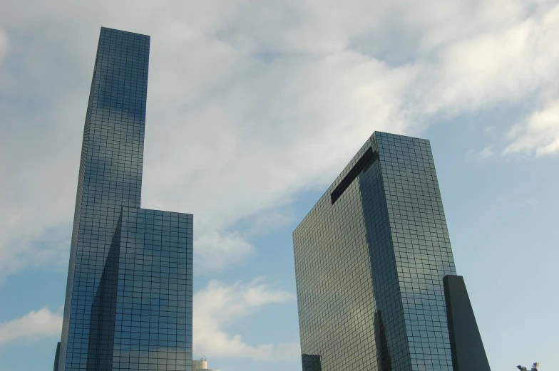 there are two tall buildings that look like some sort of skyscr