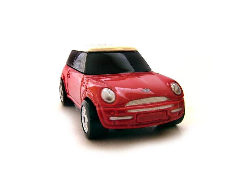 a toy mini - car on white with soft lighting