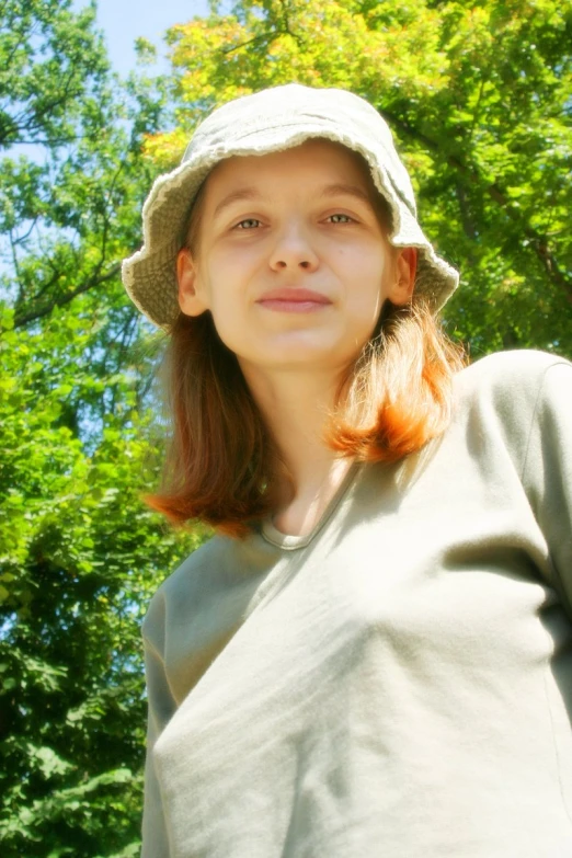 a beautiful woman in a hat posing for a po