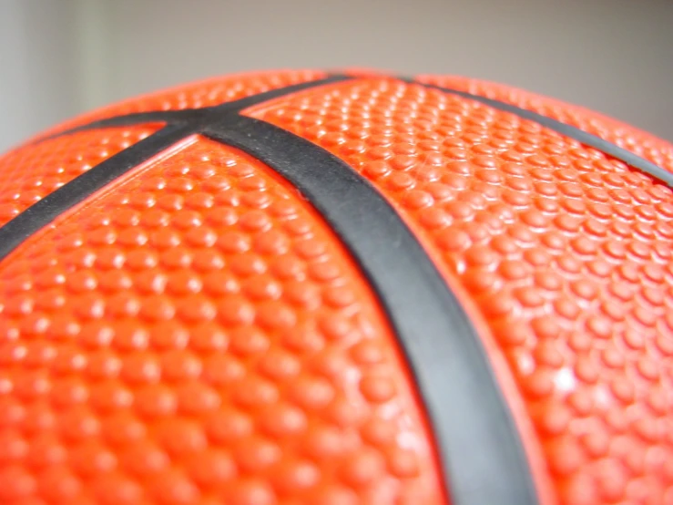 closeup of an orange basketball on a white surface