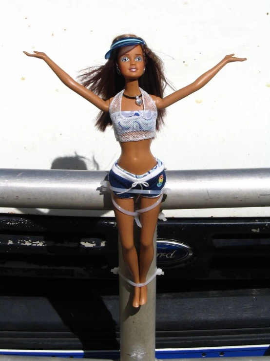 a barbie doll wearing a bikini top and high - rise shorts