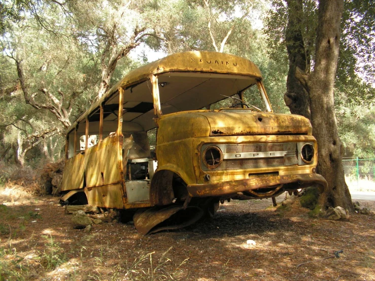 the front end of a yellow, abandoned bus