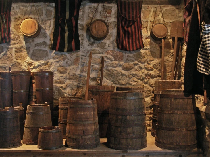 lots of barrels sitting in a room next to a wall