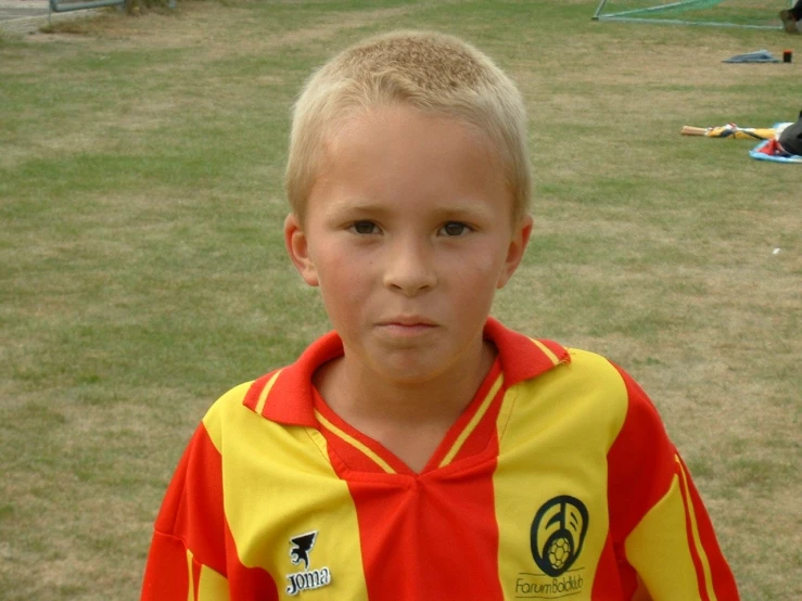 the little boy in the jersey is ready to play soccer