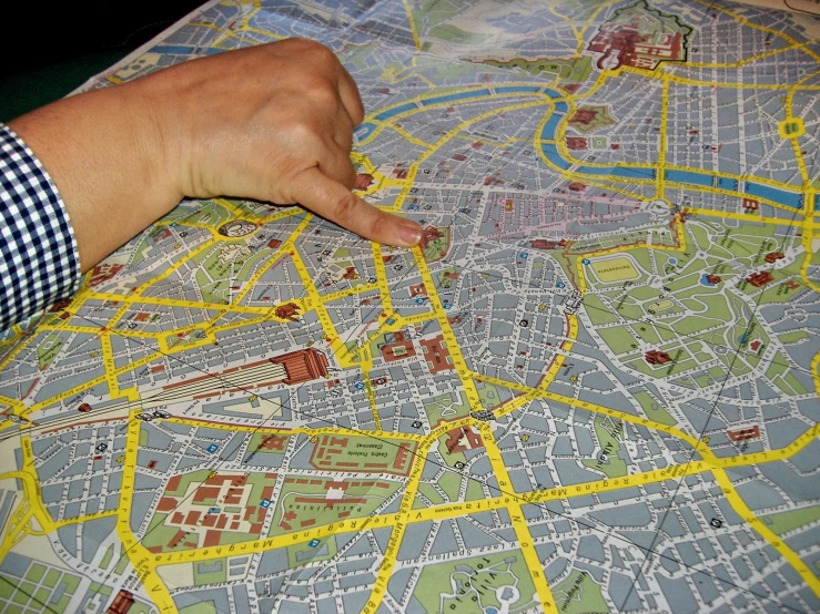 a person pointing to a large city map on the floor