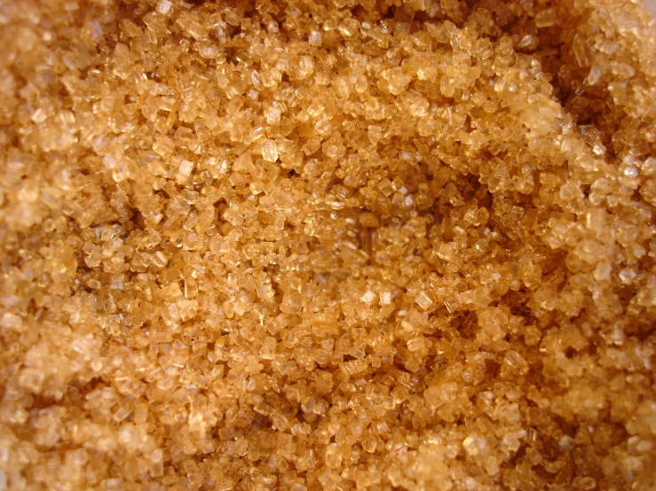 a mixture of yellow and brown sugar on a white surface