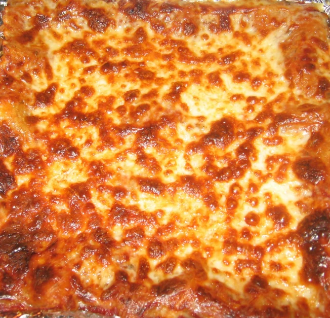 a close up of a square pizza on a pan