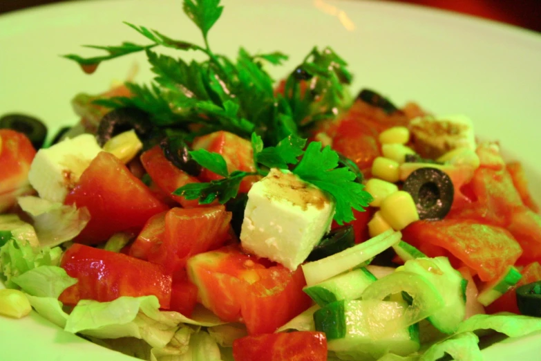 a plate full of salad with lots of veggies