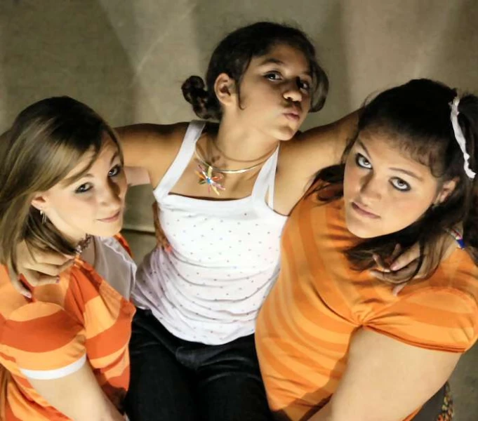 four girls in tank tops looking to the side