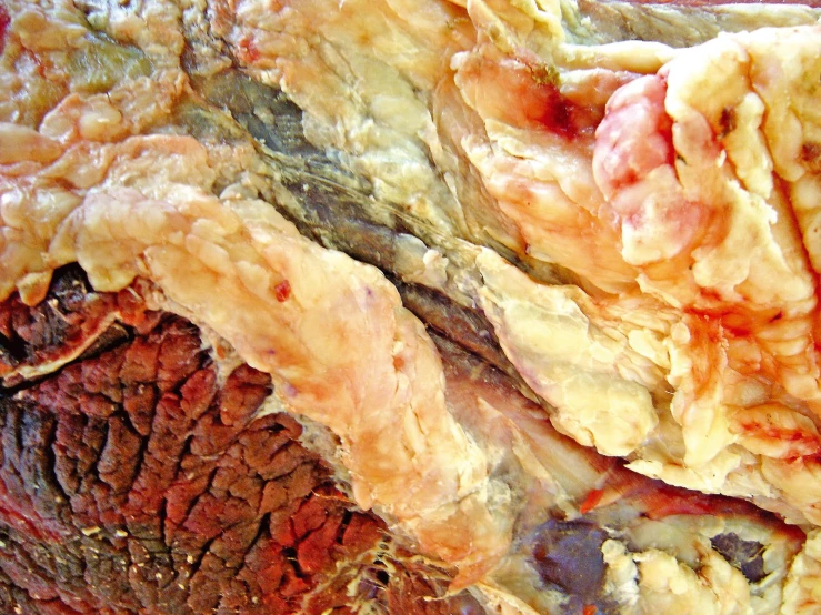 a close up of colorful rock, with brown and red streaks