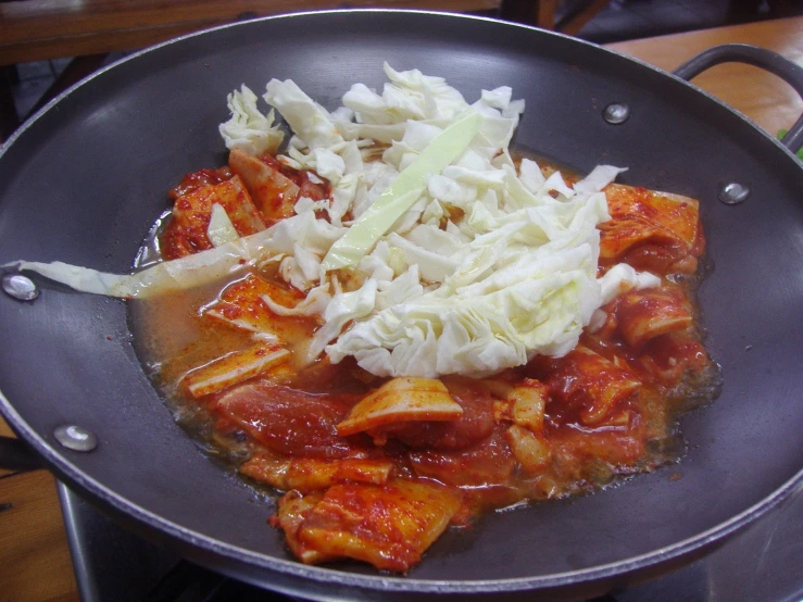 the stew is prepared in the pan on the stove