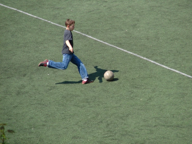 a man on a field kicking a ball
