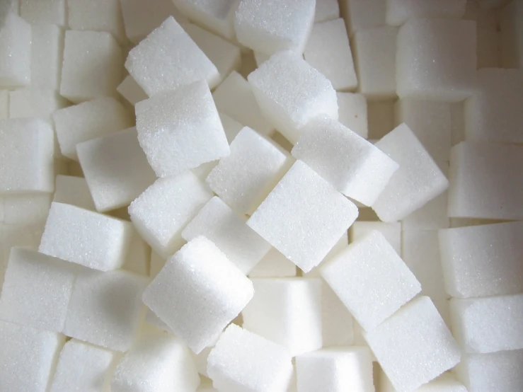 some sugar cubes are being cut up in half