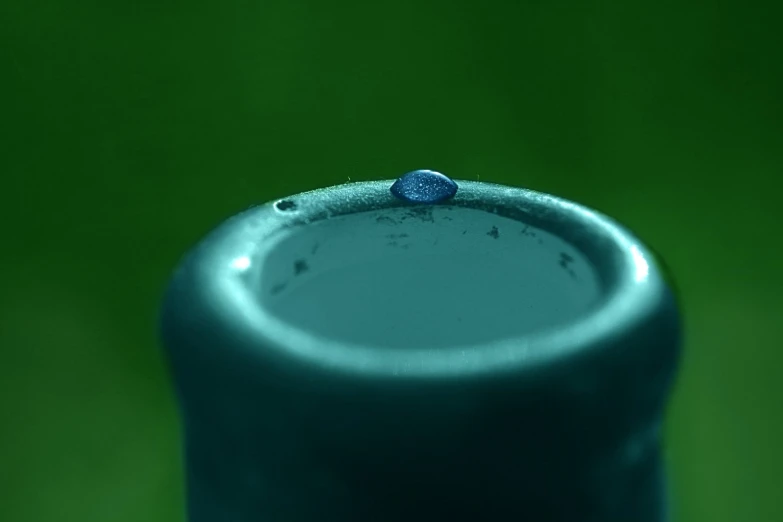 the blue jar has a small drop on the top of it