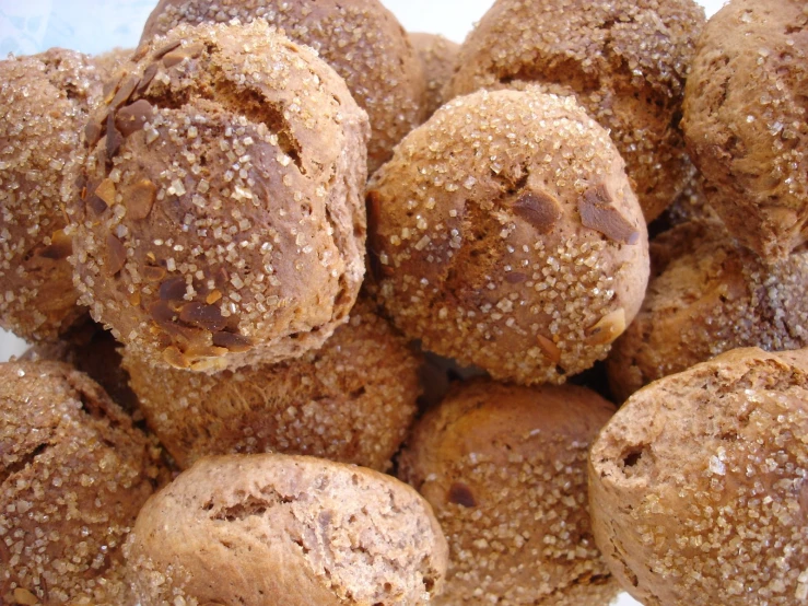 a pile of rolls that are topped with brown sugar