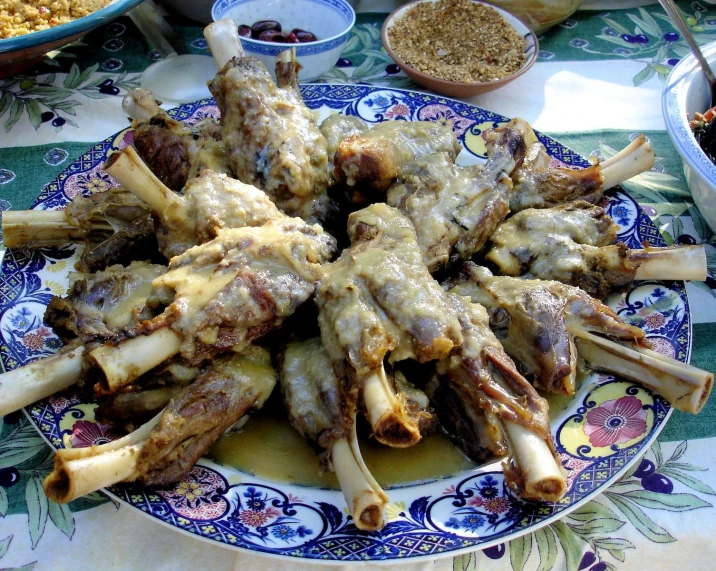 a plate of chicken wings are shown with spices