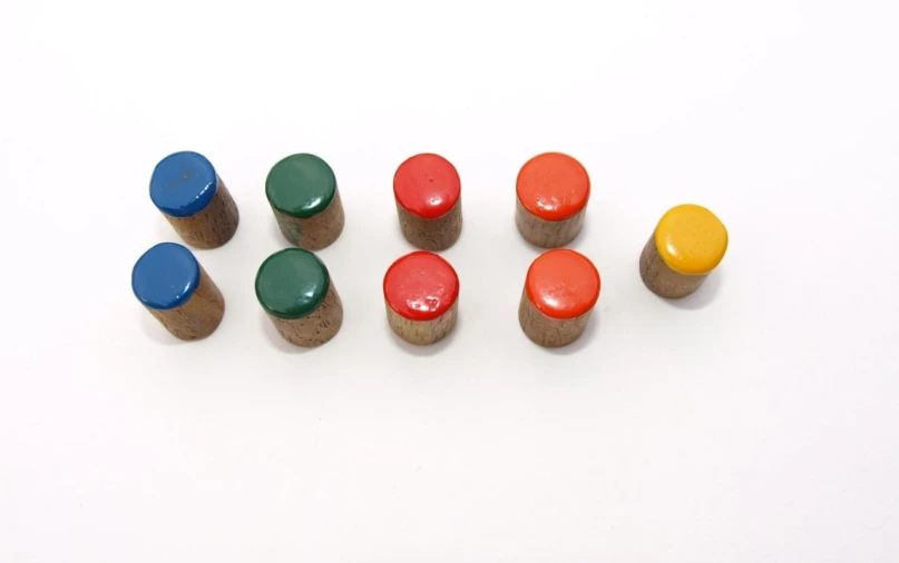 the wooden toy pegs are marked with different colors