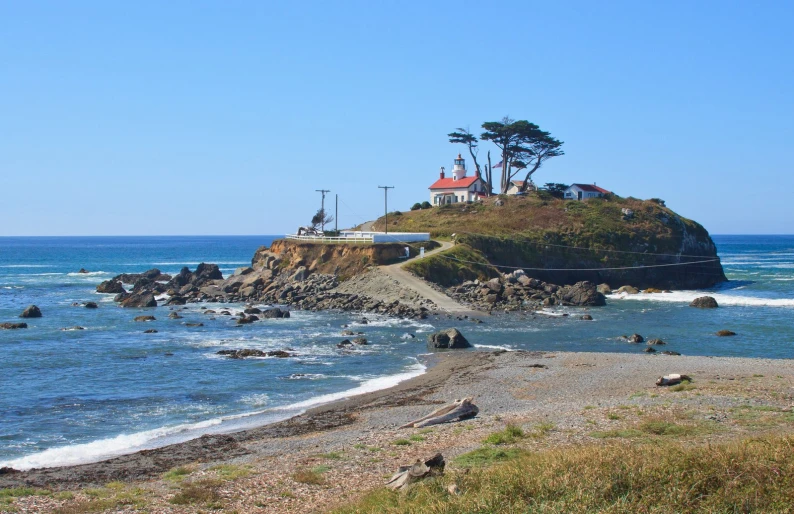 the small house sits on an island in the middle of the ocean