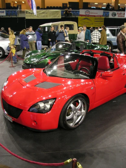 red sports car parked in an auto show