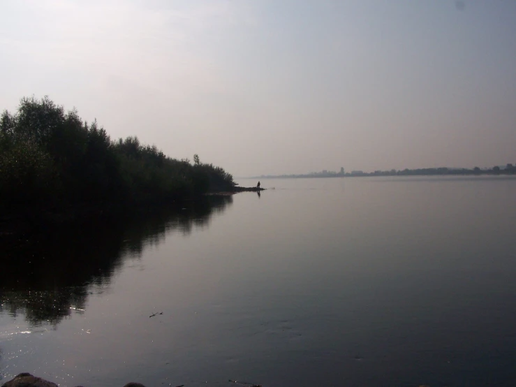 a view of a small body of water on a foggy day