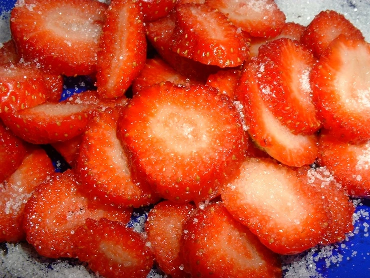 sugar covered strawberries on a blue plate