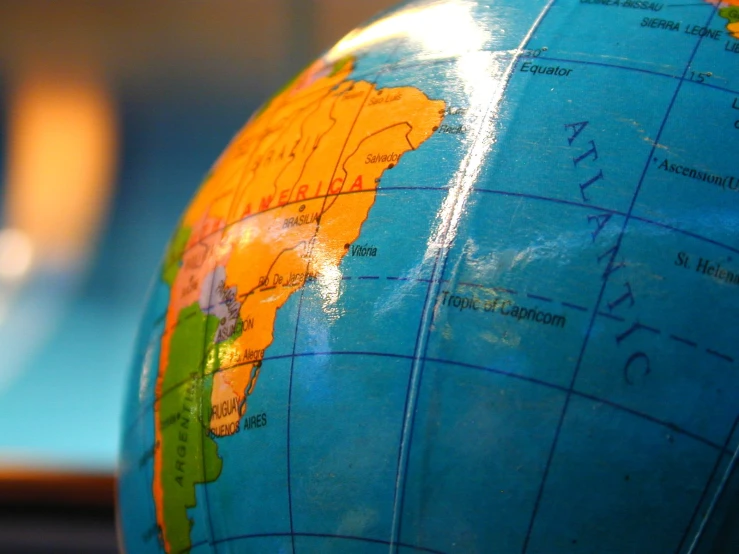 close up of an earth globe with the name of the country