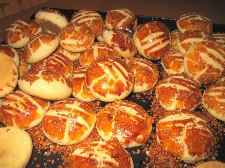 freshly baked orange glazed buns are being prepared