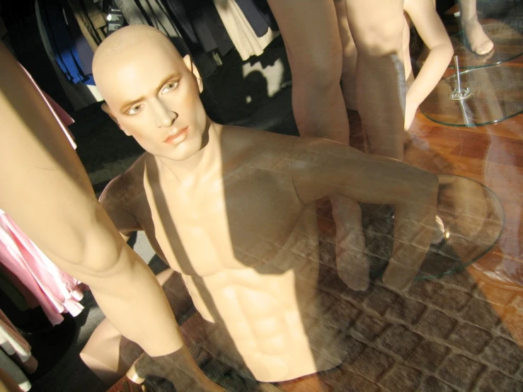 an image of a mannequins that are inside a glass display