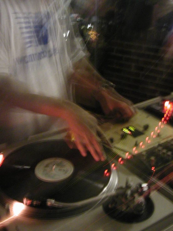 a man in an apron playing the music on a turntable