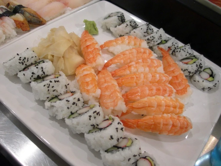 an assortment of sushi sitting on top of a white plate