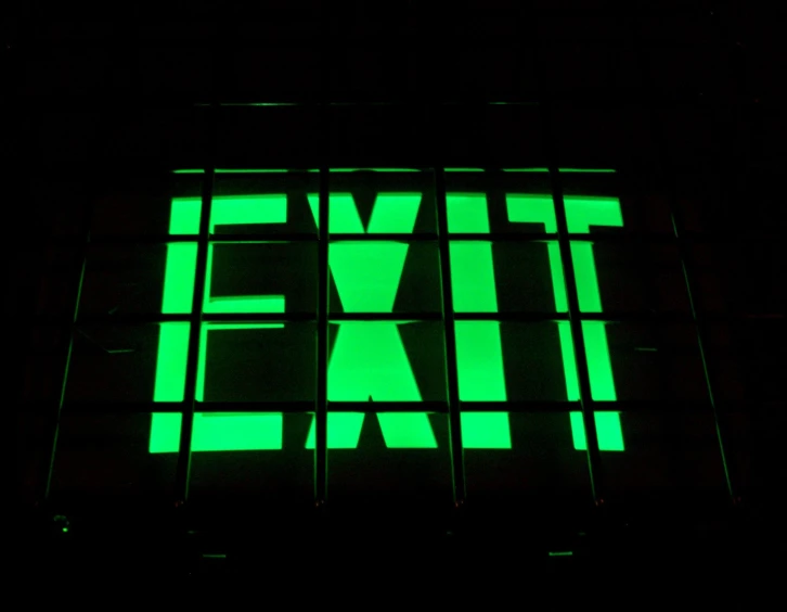 a exit sign lit up green to reveal the exit