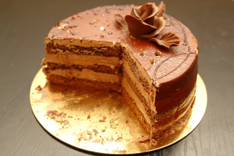 a layered cake with one slice cut off and sitting on a plate
