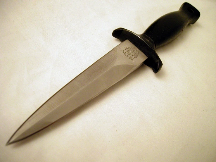 a black and silver large kitchen knife sitting on top of a counter