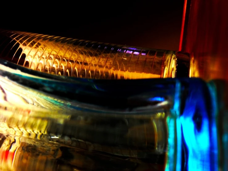 some yellow and red wine bottles with different colored glass caps