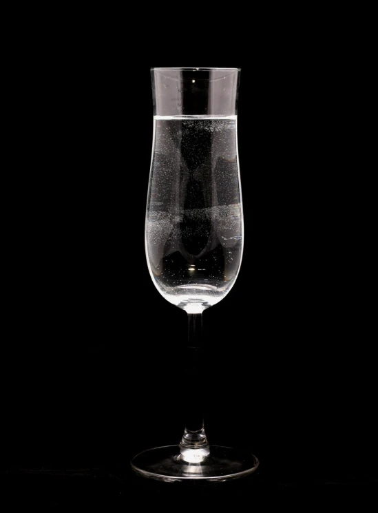 a wine glass sitting on top of a black table