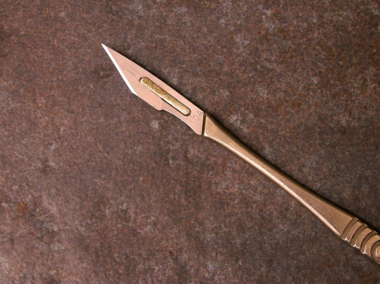 a metal instrument resting on top of a brown floor