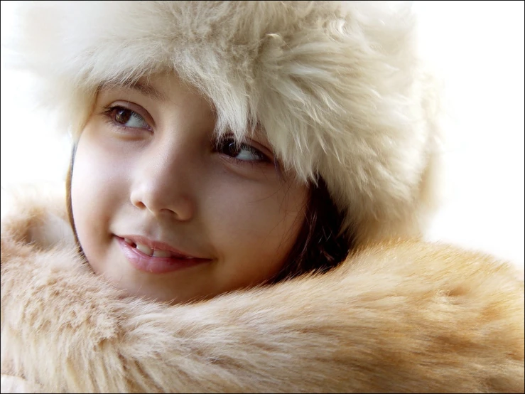 the girl is wearing a fur hat and she has blue eyes
