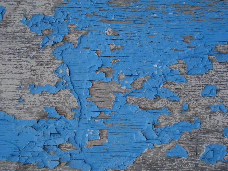 the paint peeling off of a wooden door