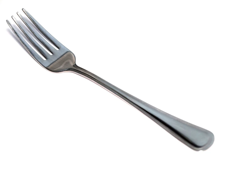 a silver fork that is on the table