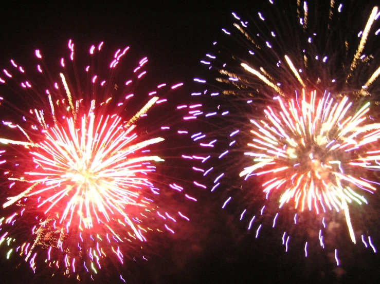 fireworks are being display at night sky with multiple colors