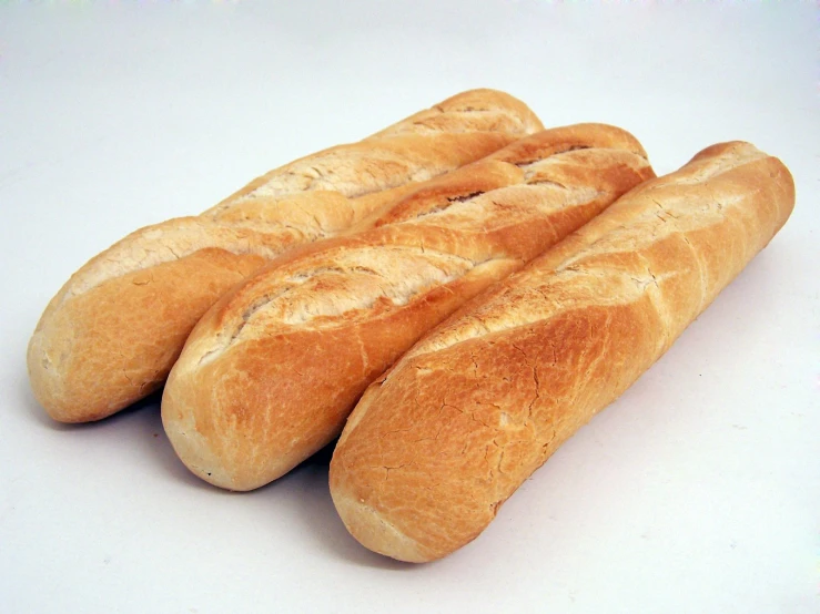 four loaves of bread sit in a row